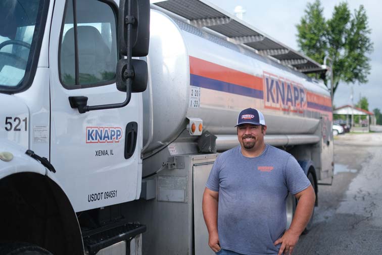 Fuel truck driver standing next to truck in Xenia, Illinois