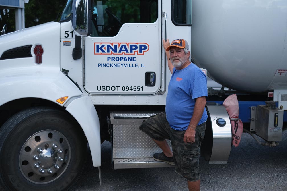 Propane truck driver standing by propane truck at the Pinckneyville, Illinois Knapp location